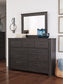 Brinxton King/California King Panel Headboard with Mirrored Dresser and Chest